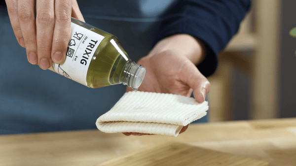 Someone is applying wood treatment oil on a towel.