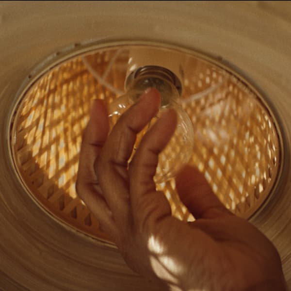Someone replacing a light bulb