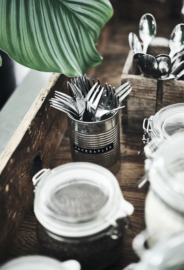 Stainless steel forks stored in a metal can.
