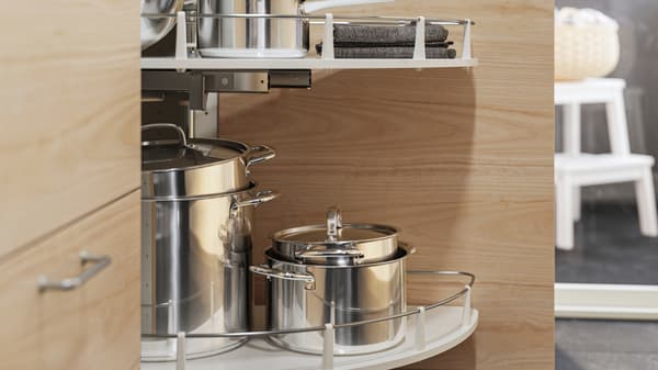 Stainless steel IKEA 365+ pots with lids in an UTRUSTA corner base cabinet pull-out fitting in a light ash effect cabinet.