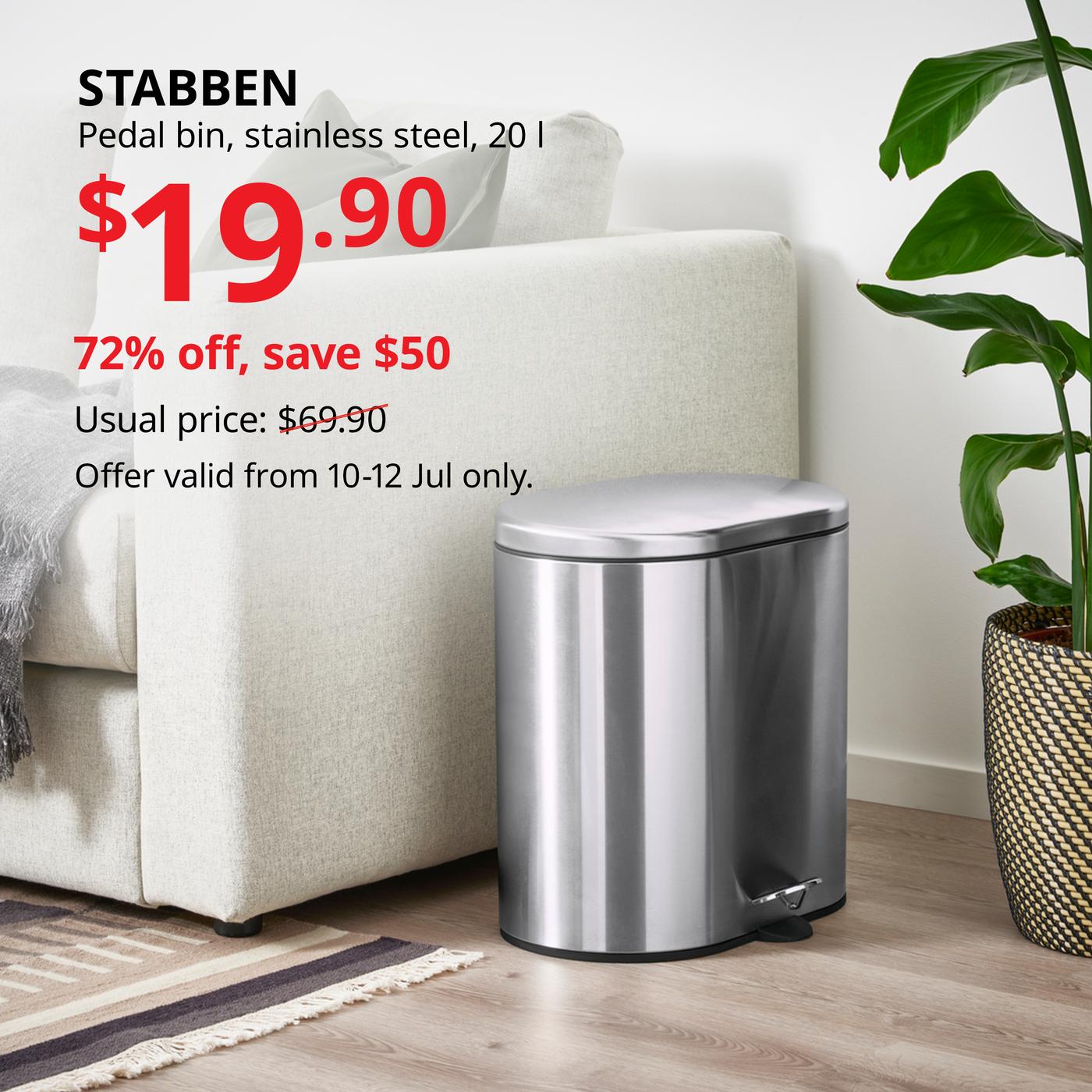 Stainless steel STABBEN pedal bin placed beside a white sofa and indoor plant.