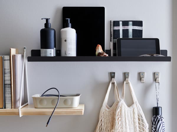 Standing on an old, worn chest of drawers are a set of RAGGISAR textile baskets, filled with trinkets and clutter.