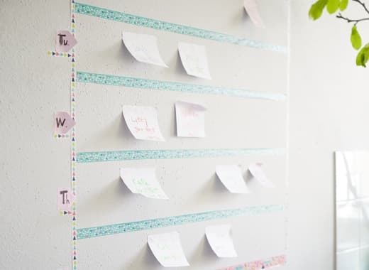 Stick a weekly calendar on a kitchen wall using IKEA SPRUDLA tape. The tape comes in pink and turquoise multi-patterned hues. Sticky notes are used to keep track of appointments so they don’t get forgotten about.