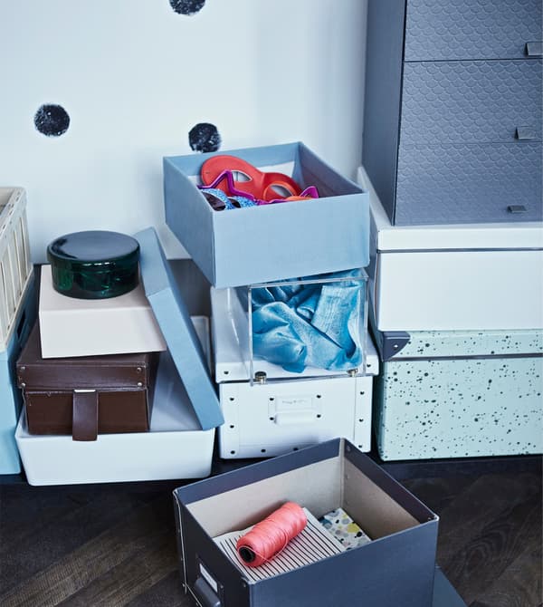 Storage boxes stacked in a hallway.