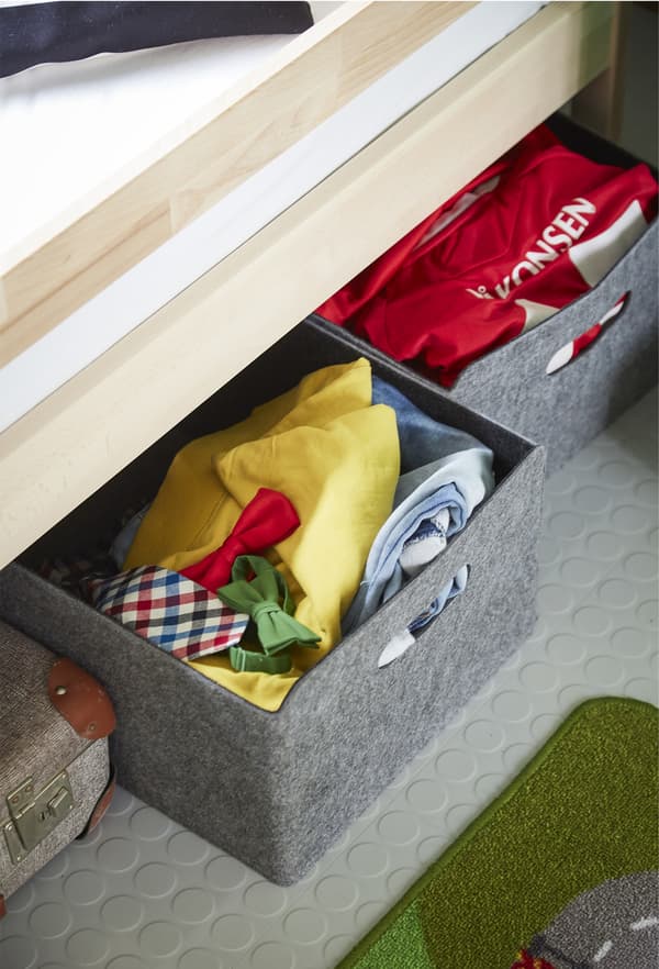 Storage boxes under a bed.
