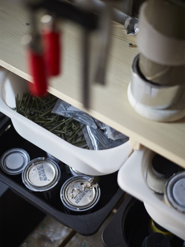 Storage boxes underneath a shelf