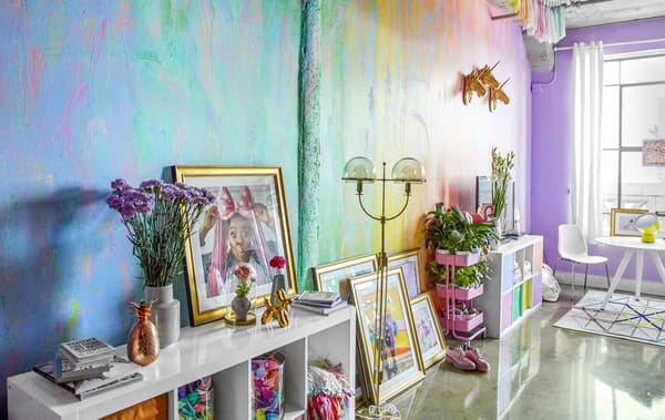 Storage units against a rainbow-coloured wall.