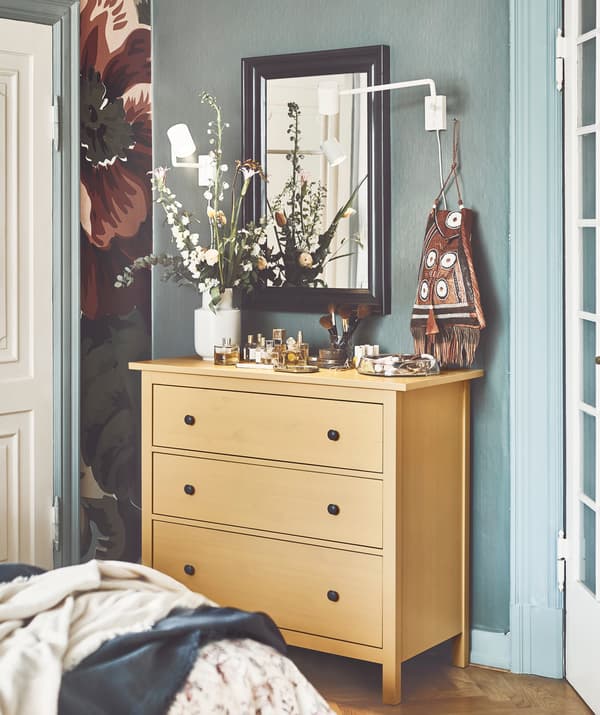 Store the stuff you don’t want to show off, such as underwear and t-shirts, inside IKEA HEMNES yellow chest of 3 drawers.