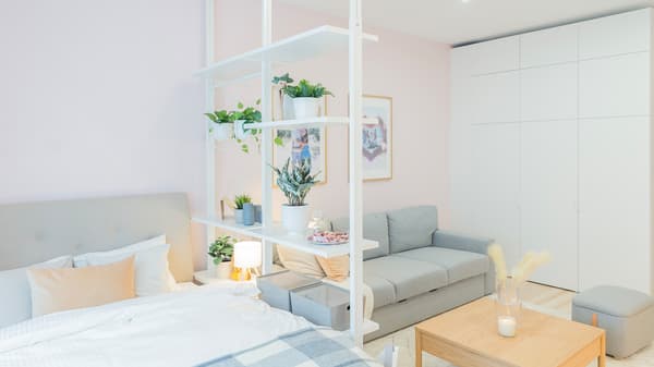 Studio apartment view with bed, sofa and wardrobe