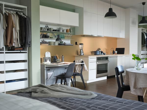 Studio home showing a combined live / work space featuring the IKEA PAX wardrobe system. 
