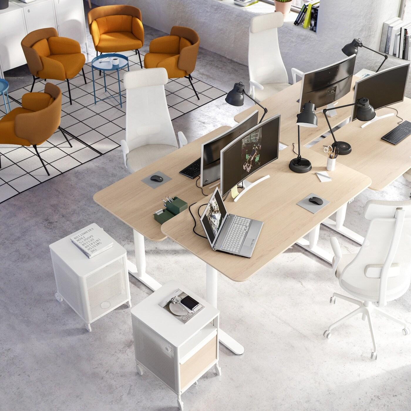 Supervision of a group of desks with mobile pedestals and desk chairs.
