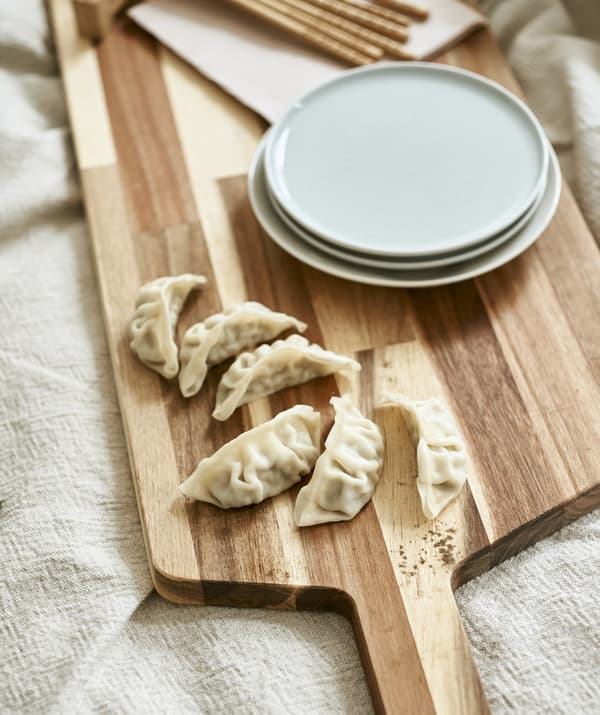 Sushi and plates on a wooden board.