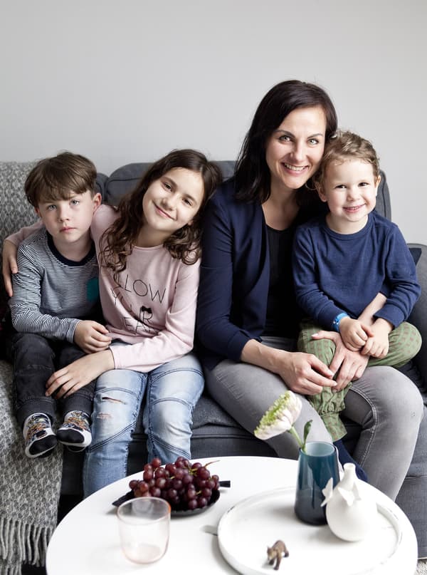 Sylke and her children on their living room sofa.