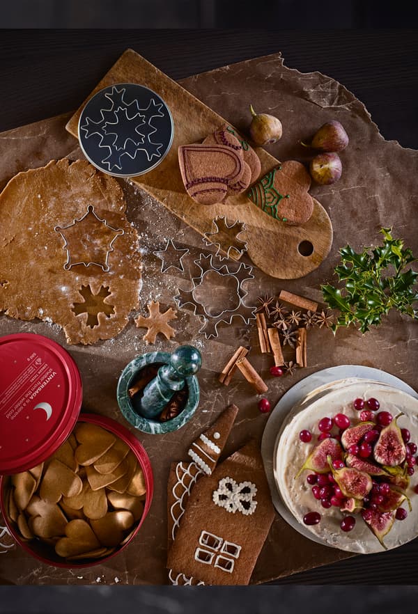 Table covered with cookie dough, heart-shaped biscuits and ginger bread