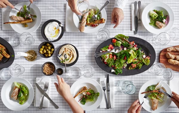 Table dressée avec salade, pain et autres, vue d’en haut.