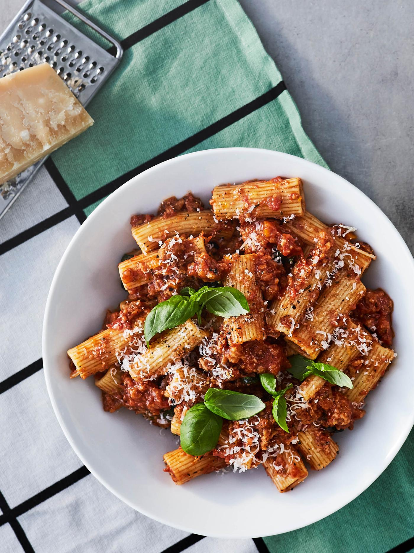 Talíř s boloňskými těstovinami leží na utěrce vedle struhadla VARDAGEN.