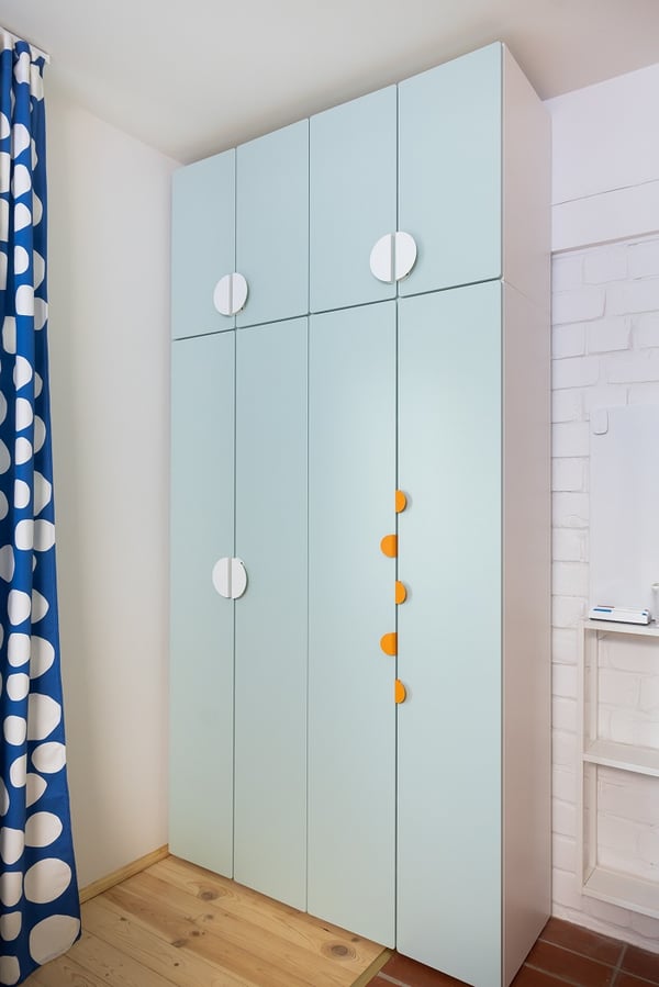 Tall children’s wardrobe with light blue doors and modern handles
