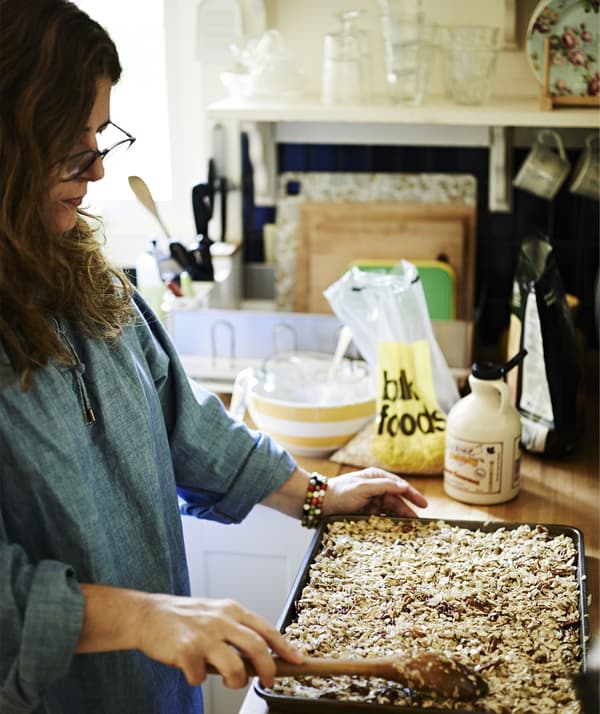 Tamar presses the granola mixture onto a baking sheet