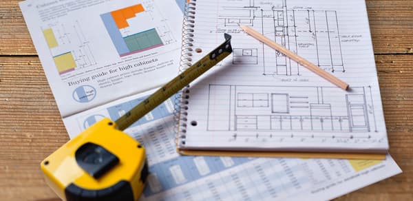 Tape measure on a table with kitchen plans