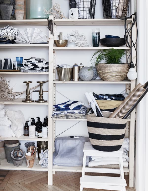 Textiles, plants and ornaments on a shelving unit.