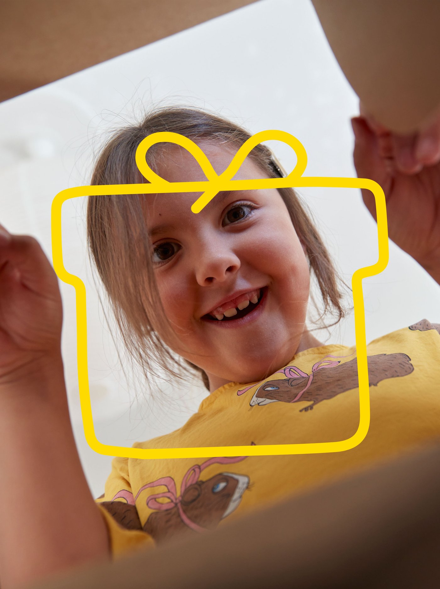 The child peeks into a box.