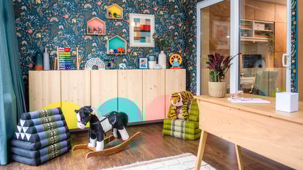 The conservatory is transformed into a multi-functional space, with a workspace and plenty of toy storage and play solutions.