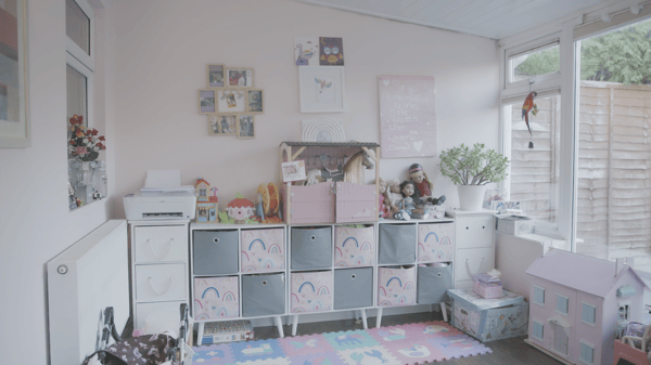 The conservatory playroom cluttered with toys
