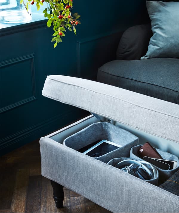 The gray-beige IKEA STOCKSUND bench with a hardwearing textile cover offers extra seating and hidden storage.
