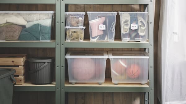 The IKEA BROR shelving unit storage solution in green featuring everyday housegod items on the shelf in IKEA storage bins.