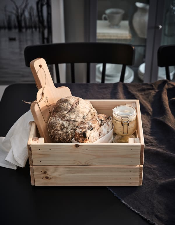 The IKEA KNAGGLIG breadbox is made of smooth and recyclable light pine wood and can be used as a food storage box after your friend finishes what’s inside.