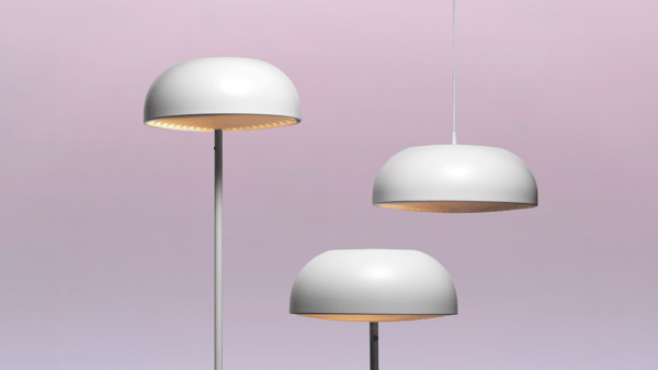 The image showcases the IKEA NYMÅNE lamp series, featuring a modern and sleek design. Three lamps are displayed: a floor lamp, a table lamp, and a pendant lamp, all with smooth, white dome-shaped shades. The clean lines and minimalist style make these lamps ideal for contemporary interiors. The soft, even lighting from these lamps creates a calm and inviting atmosphere. The background is a gradient of light pink and purple, highlighting the elegant simplicity of the NYMÅNE series.