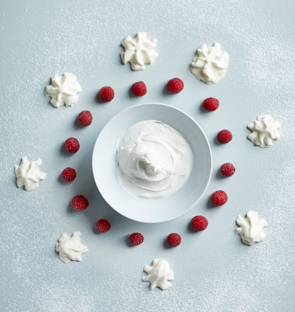 The ingredients for raspeberry frozen yogurt pops are laid out in a graphic manner.