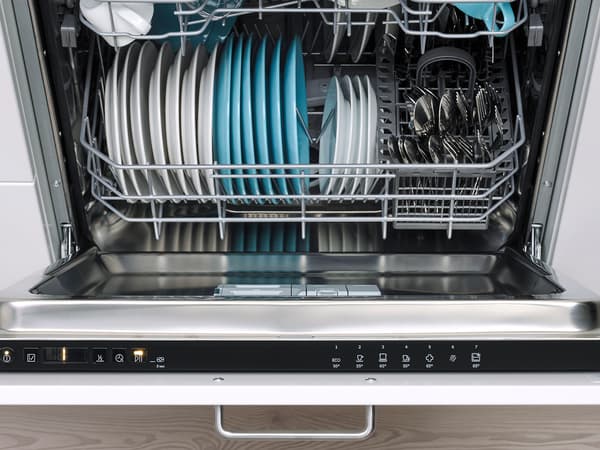 The inside of a dishwasher with clean dishes perfectly stacked.