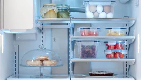 The inside of a STJÄRNSTATUS fridge featuring multiple food storage containers.