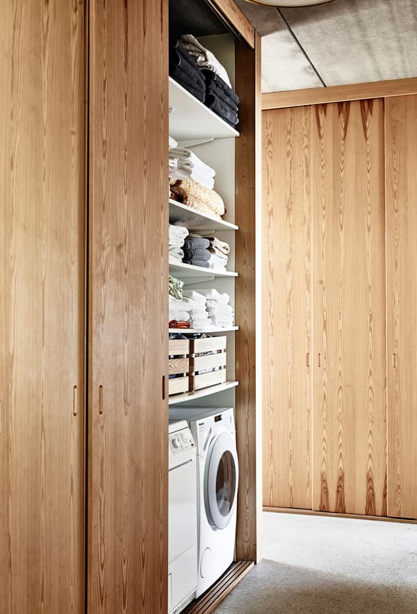 The laundry area hides behind space-saving sliding doors