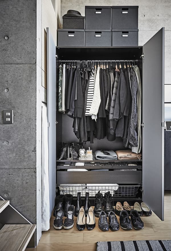 The monochrome contents of an open wardrobe.