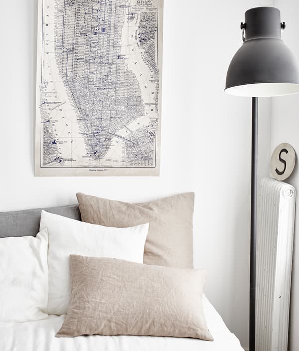 The neutral white and beige palette of these bed linens helps keep a blended live/work space calm.