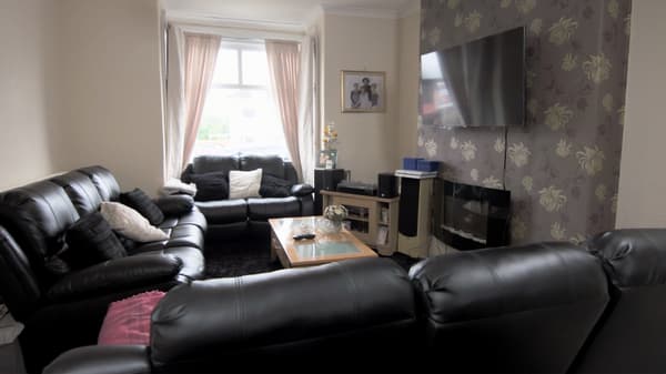 The open plan living and dining space with clutter and cables everywhere