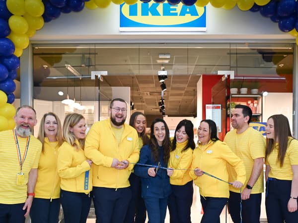 The store team outside the store cutting the ribbon
