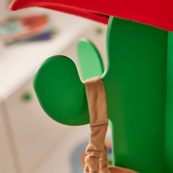 The strap of a bag hanging from a cactus-shaped coat rack 