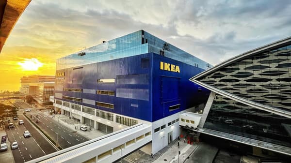 The sun rises on a cloudy day over the IKEA blue box at Pasay City, Philippines