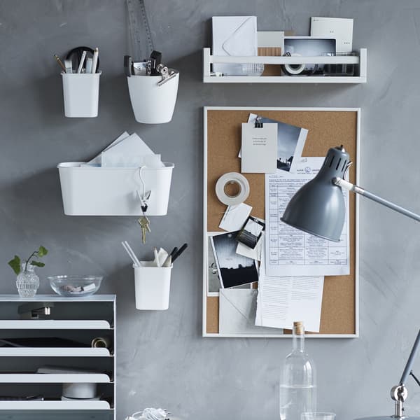The VAGGIS memo board on a wall covered in papers and notes, surrounded by other desk organizers.