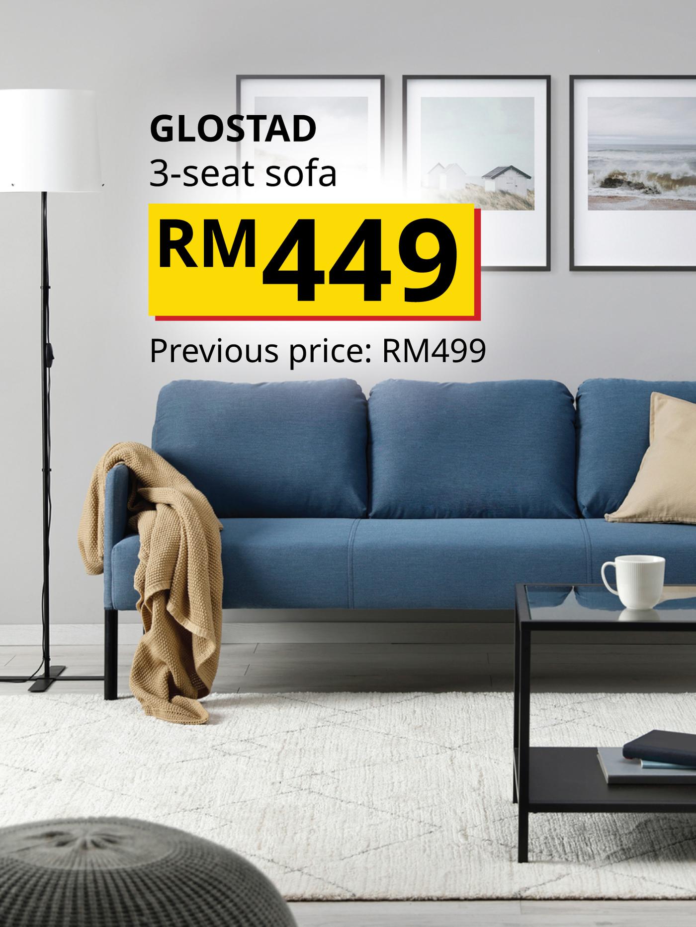 The visual shows a blue GLOSTAD 3-seat sofa with cushions and a throw in a bright living room. The text reads: “GLOSTAD 3-seat sofa, RM449. Previous price: RM499.”