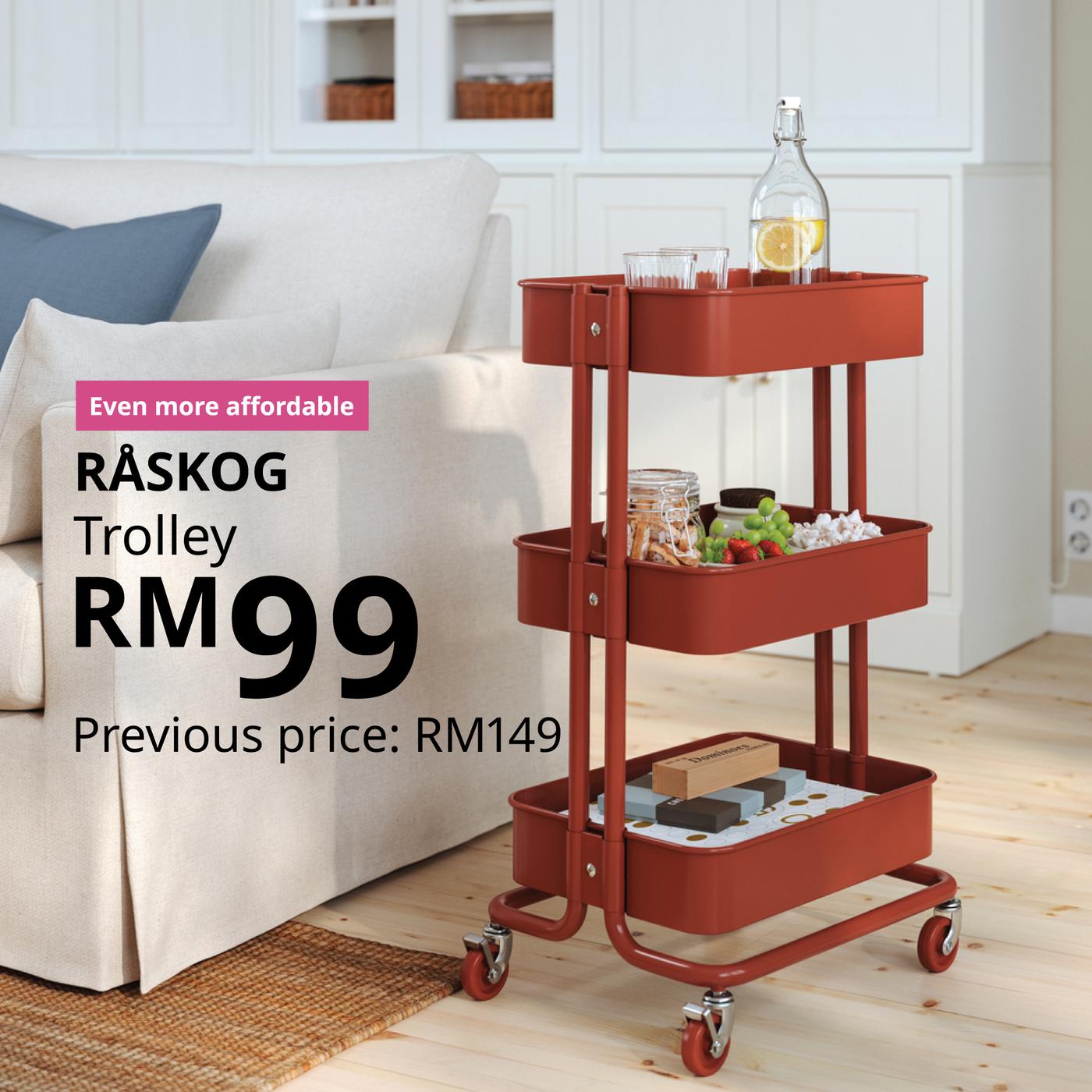 The visual shows a red RÅSKOG trolley filled with drinks, snacks and other items beside a sofa in a bright living room. The text reads: “Even more affordable. RÅSKOG trolley, RM99. Previous price: RM149.”