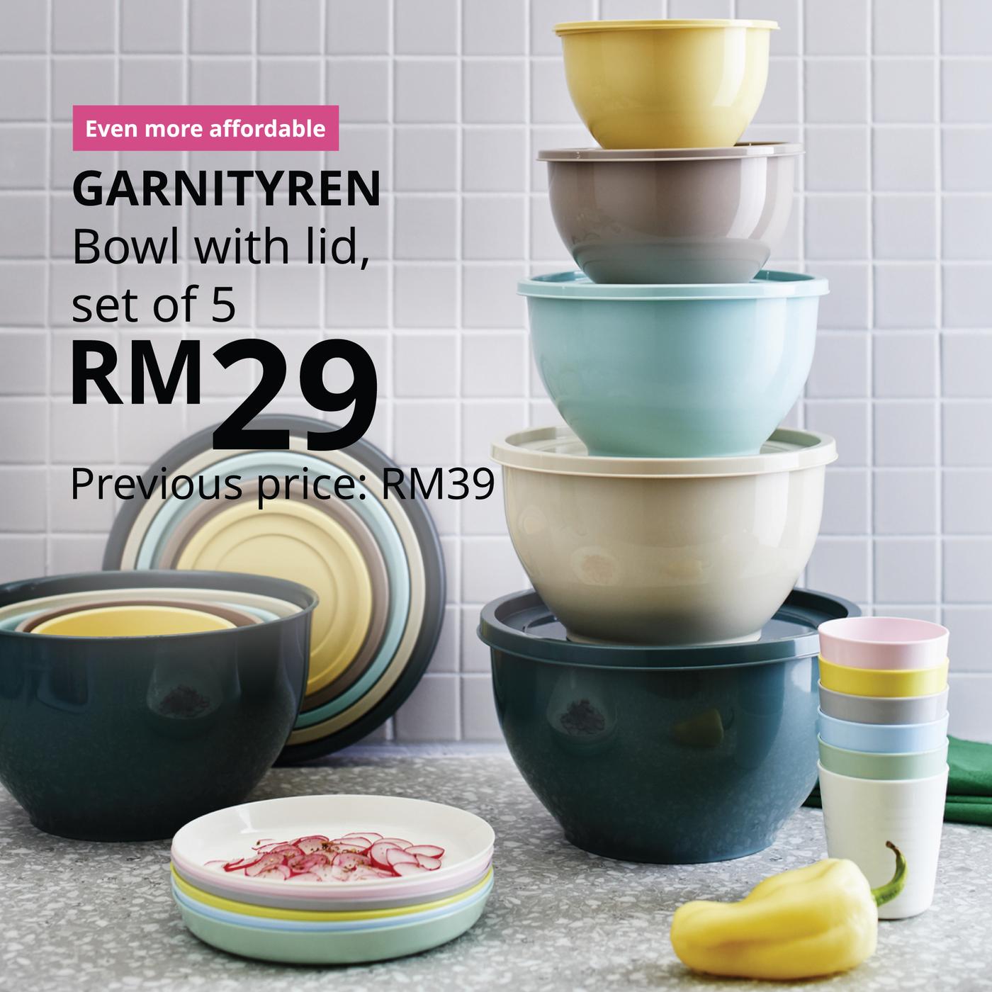 The visual shows a stack of GARNITYREN bowls with lids in different colours on a kitchen worktop. The text reads: “Even more affordable. GARNITYREN bowl with lid, set of 5, RM29. Previous price: RM39.”