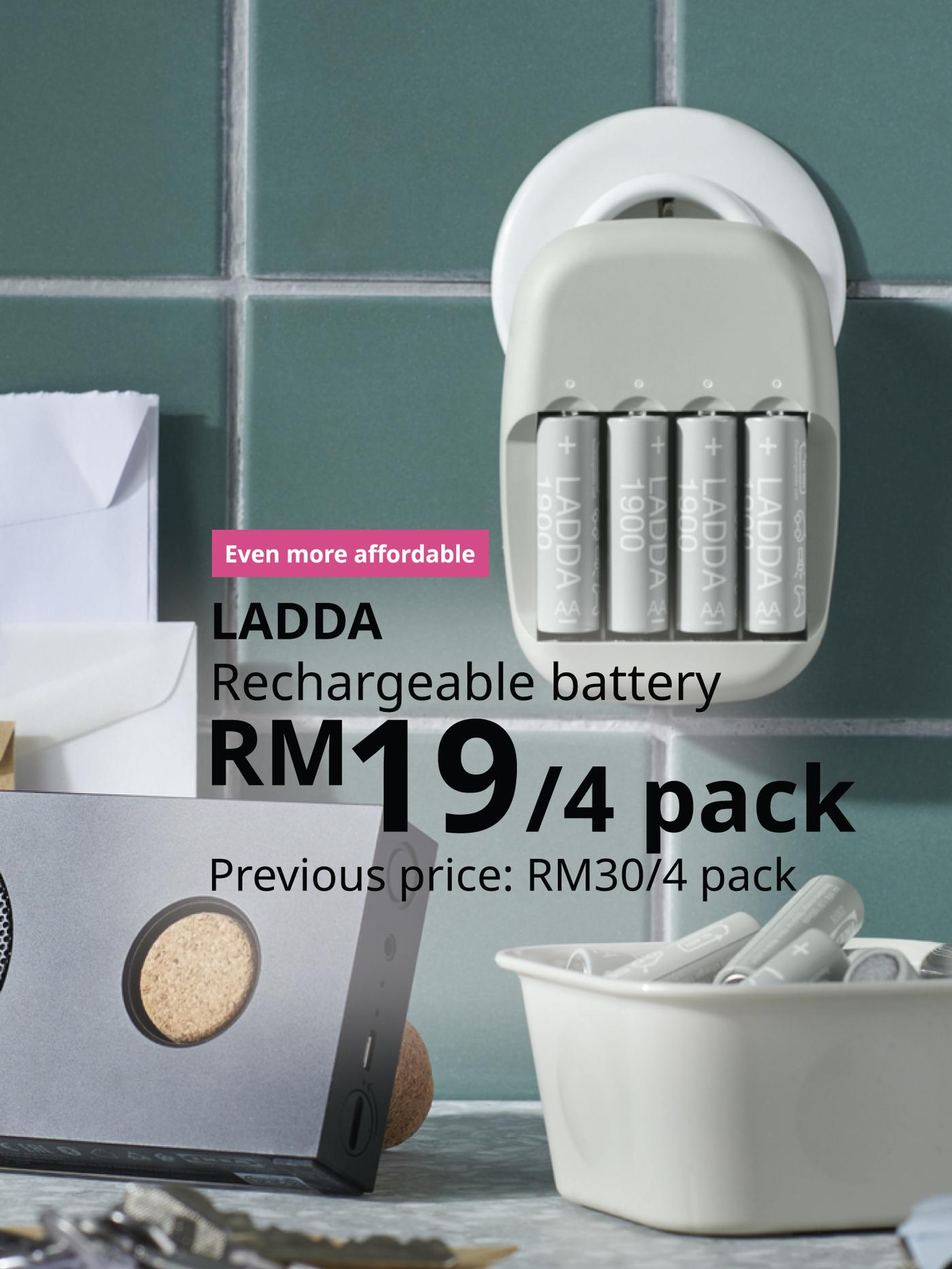 The visual shows LADDA rechargeable batteries in a battery charger, with additional batteries and storage items nearby. The text reads: “Even more affordable. LADDA rechargeable battery, RM19 for a pack of 4. Previous price: RM30 for a pack of 4.”