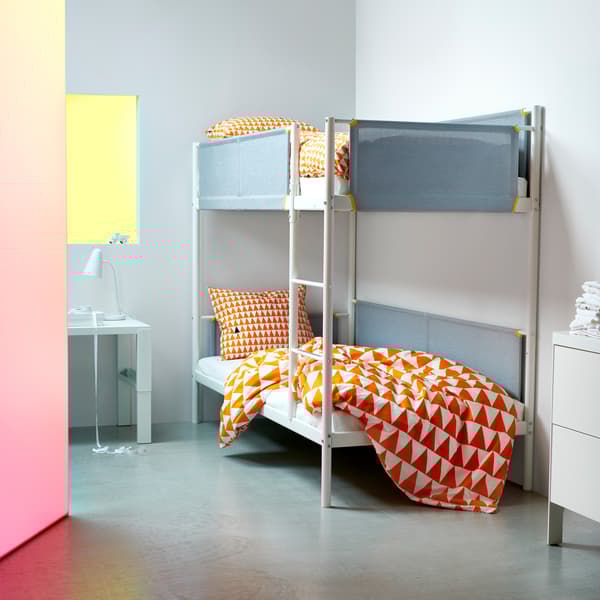 The white VITVAL bunk bed in metal with a ladder and guard rails made of grey fabric.