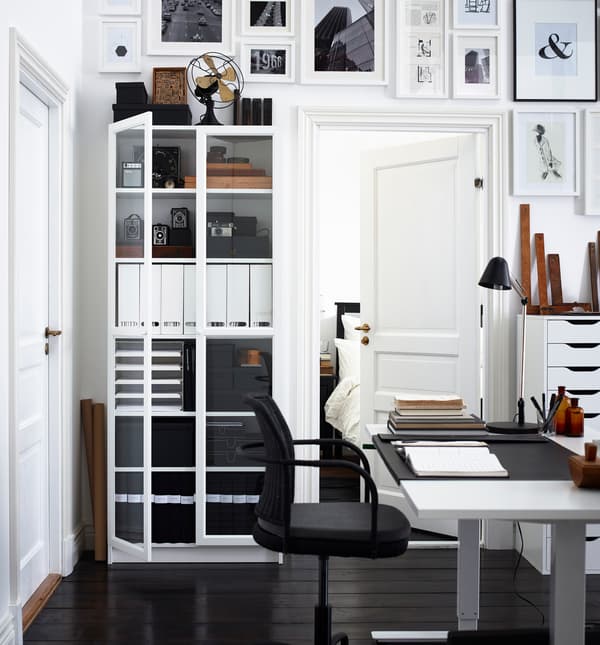 This classic home office has dark floors and white walls. The simple colour combo keeps the space feeling uncluttered.