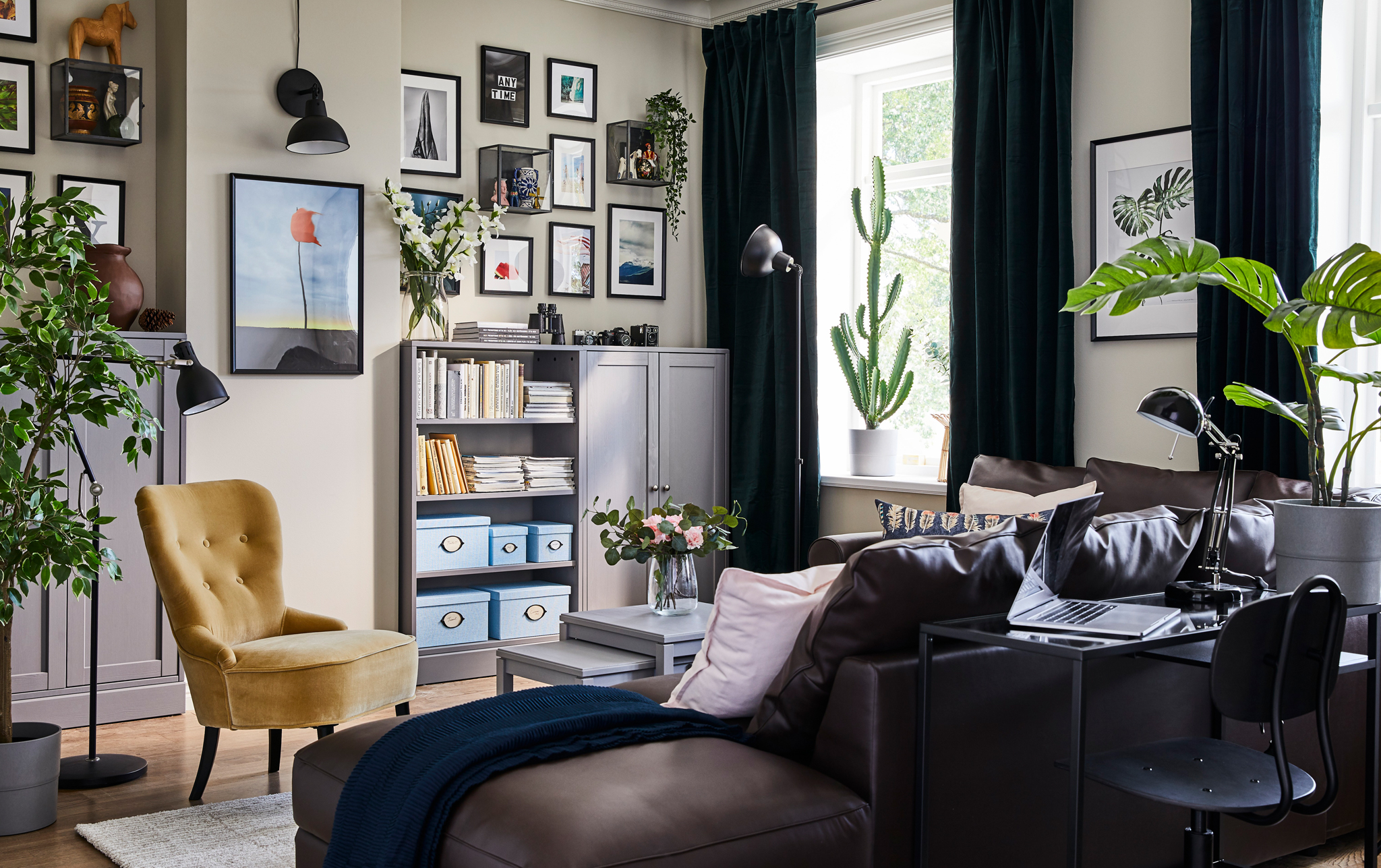 This colourful small living space is filled with KNOPPÄNG black picture frames, BARKHYTTAN glass display boxes and HAVSTA unit that store travel memories.