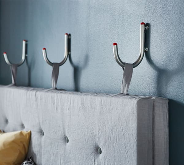 This cool sofa is made using fabric-covered mattresses. Its stylish backrest hangs on the wall and can easily be taken down for floor lounging. Here is how to make it.
